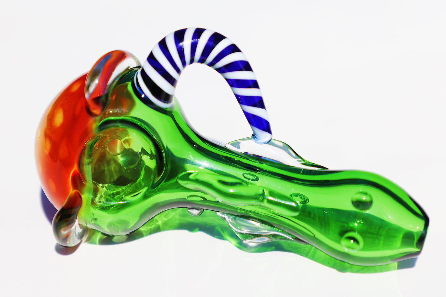 Enigmatic Monkey Glass Smoking Pipe with a Colorful Twist, showcasing green and blue hues, a compact and intricate design for an enhanced smoking experience
