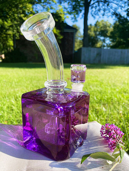 Unleash a frost-enhanced smoking experience with the Smooth Chill Glycerin Coil Bong collection. Featuring elegant glassware in vibrant red, purple, and green, these square-base, bent-neck bongs with ice catchers offer a modern smoke piece design for a sleek and sophisticated session