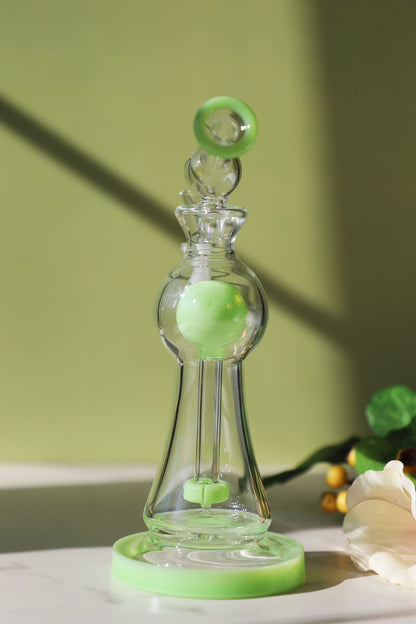 Enchanted Garden Mini Bong, the Ultimate Girly Glass Piece for Sophisticated Smokers with purple, pink, and green accents, offering an Ultimate Smooth Experience with Curve Percolator Bong, Green Glass Bong, and Advanced Filtration for a Sophisticated Smoking Session.