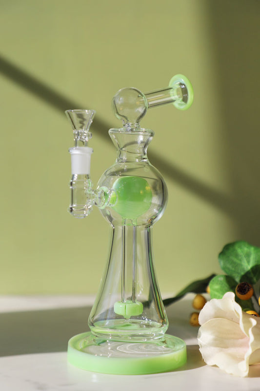 Enchanted Garden Mini Bong, the Ultimate Girly Glass Piece for Sophisticated Smokers with purple, pink, and green accents, offering an Ultimate Smooth Experience with Curve Percolator Bong, Green Glass Bong, and Advanced Filtration for a Sophisticated Smoking Session.