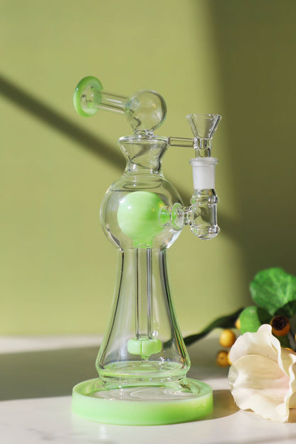 Enchanted Garden Mini Bong, the Ultimate Girly Glass Piece for Sophisticated Smokers with purple, pink, and green accents, offering an Ultimate Smooth Experience with Curve Percolator Bong, Green Glass Bong, and Advanced Filtration for a Sophisticated Smoking Session.