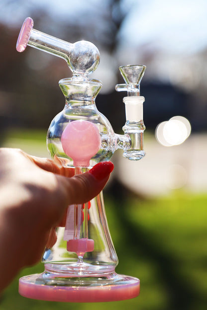 Enchanted Garden Mini Bong, the Ultimate Girly Glass Piece for Sophisticated Smokers with purple, pink, and green accents, offering an Ultimate Smooth Experience with Curve Percolator Bong, Green Glass Bong, and Advanced Filtration for a Sophisticated Smoking Session.