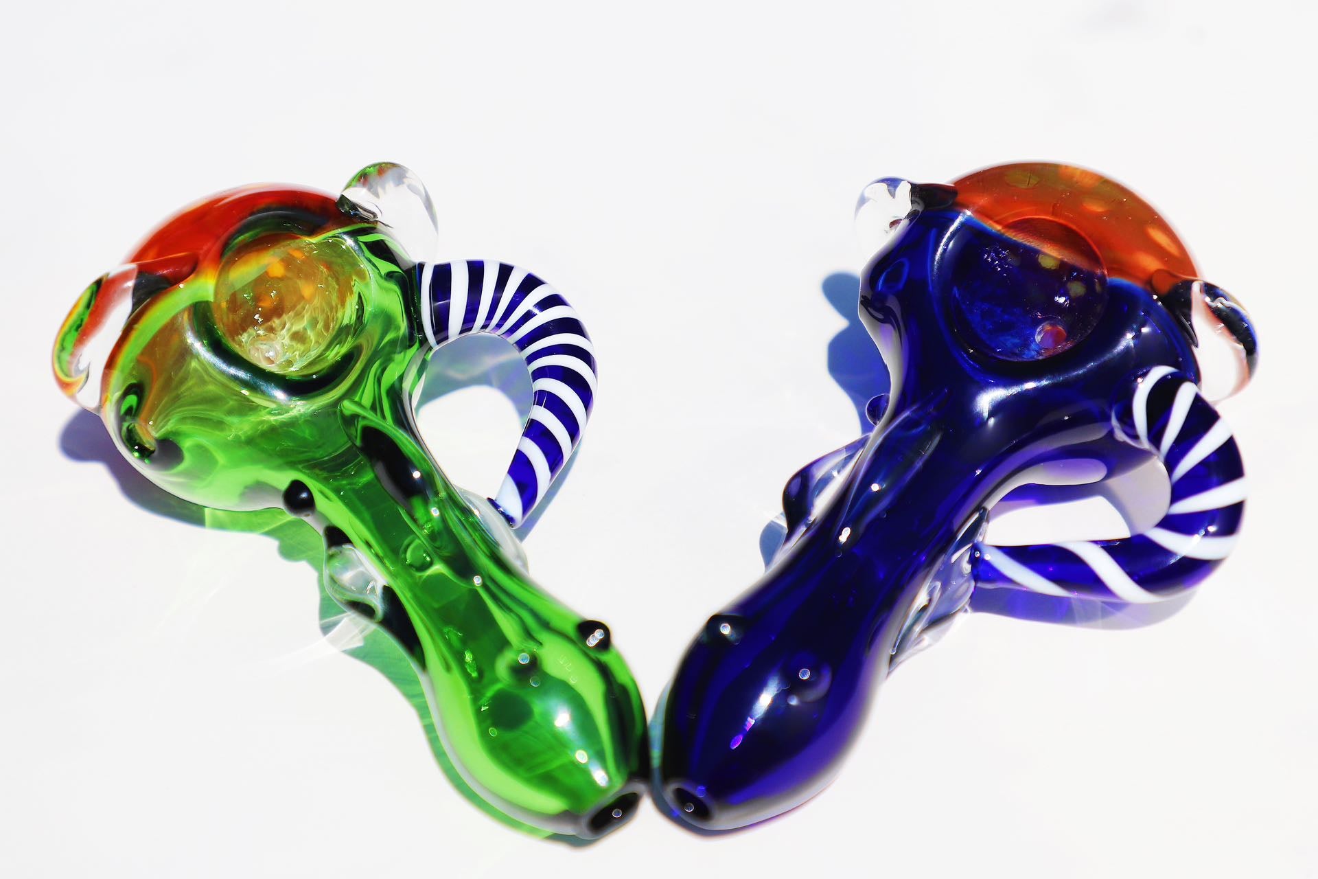 Enigmatic Monkey Glass Smoking Pipe with a Colorful Twist, showcasing green and blue hues, a compact and intricate design for an enhanced smoking experience