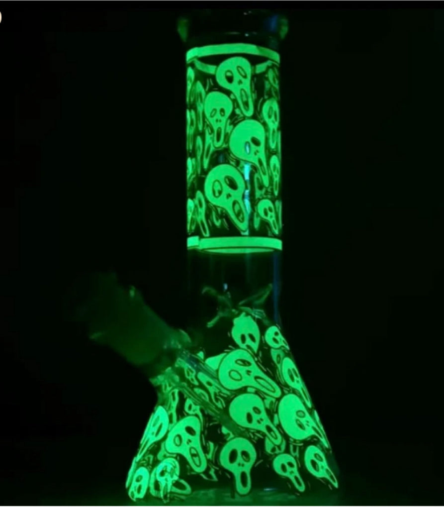 Ghostly Glow-in-the-Dark Glass Beaker Bong with Enigmatic Design, offering a Premium Smoking Experience with a Colorful Twist in Green and Blue—ideal for night-time sessions.