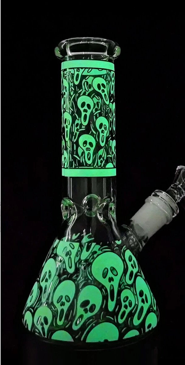 Ghostly Glow-in-the-Dark Glass Beaker Bong with Enigmatic Design, offering a Premium Smoking Experience with a Colorful Twist in Green and Blue—ideal for night-time sessions.