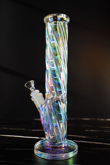 Experience a kaleidoscope of colors with this Thick, Iridescent Glass Bong. Its durable, high-quality borosilicate glass is sculpted into a Straight, Smooth-Hitting Water Pipe, an artistic smoking accessory offering both beauty and functionality. Its sleek design ensures stability for a premium, smooth hit every time. The color-changing, iridescent finish captivates with a symphony of hues, making it a unique and durable waterpipe for any collection.420