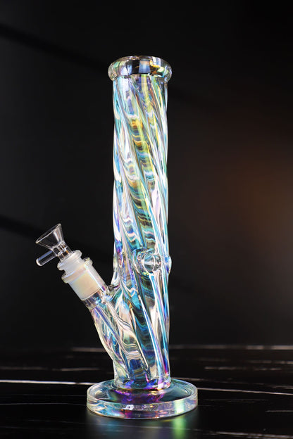 Experience a kaleidoscope of colors with this Thick, Iridescent Glass Bong. Its durable, high-quality borosilicate glass is sculpted into a Straight, Smooth-Hitting Water Pipe, an artistic smoking accessory offering both beauty and functionality. Its sleek design ensures stability for a premium, smooth hit every time. The color-changing, iridescent finish captivates with a symphony of hues, making it a unique and durable waterpipe for any collection.420