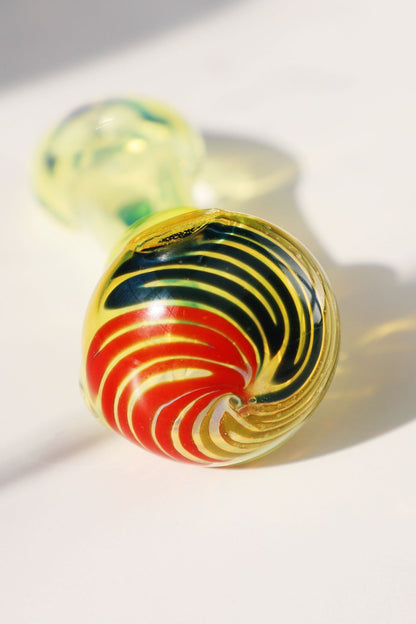 mmerse yourself in the radiance of our Handcrafted Sunburst Yellow Glass Smoking Pipe, featuring vibrant green bubble accents for a tactile experience. This artisanal handblown piece stands out with its unique spiral design, providing both aesthetic pleasure and functional smoking elegance. A perfect match for connoisseurs looking for a pipe that marries artistic craftsmanship with a splash of color for a joyful smoking session.