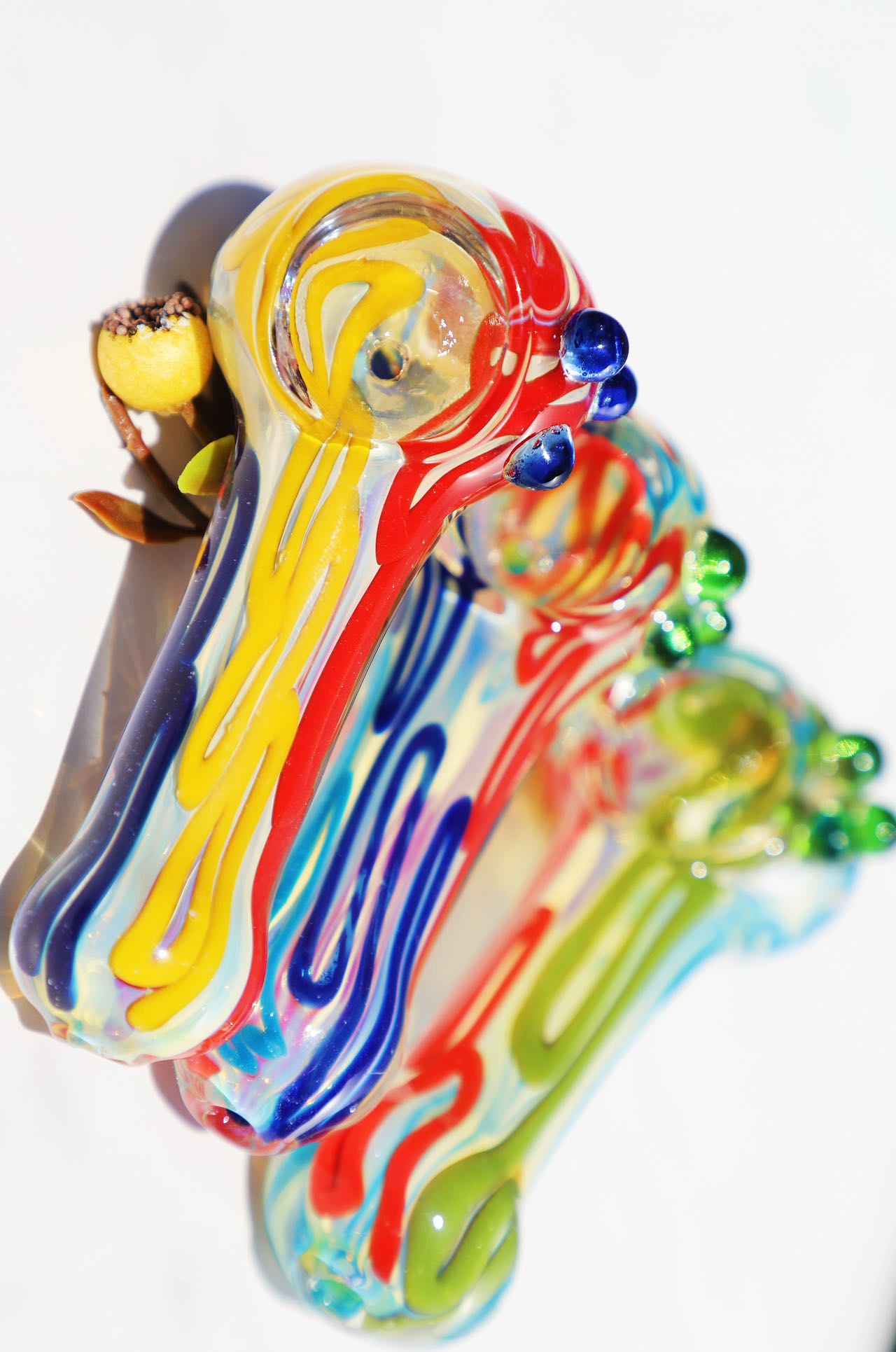 Handcrafted Vibrant Artisan Smoking Pipe, with rich swirls of sunburst yellow, deep blue, and ruby red glass. This compact, durable piece offers a uniquely artistic touch to your smoking ritual, blending bold colors and a functional design for a joyful experience.