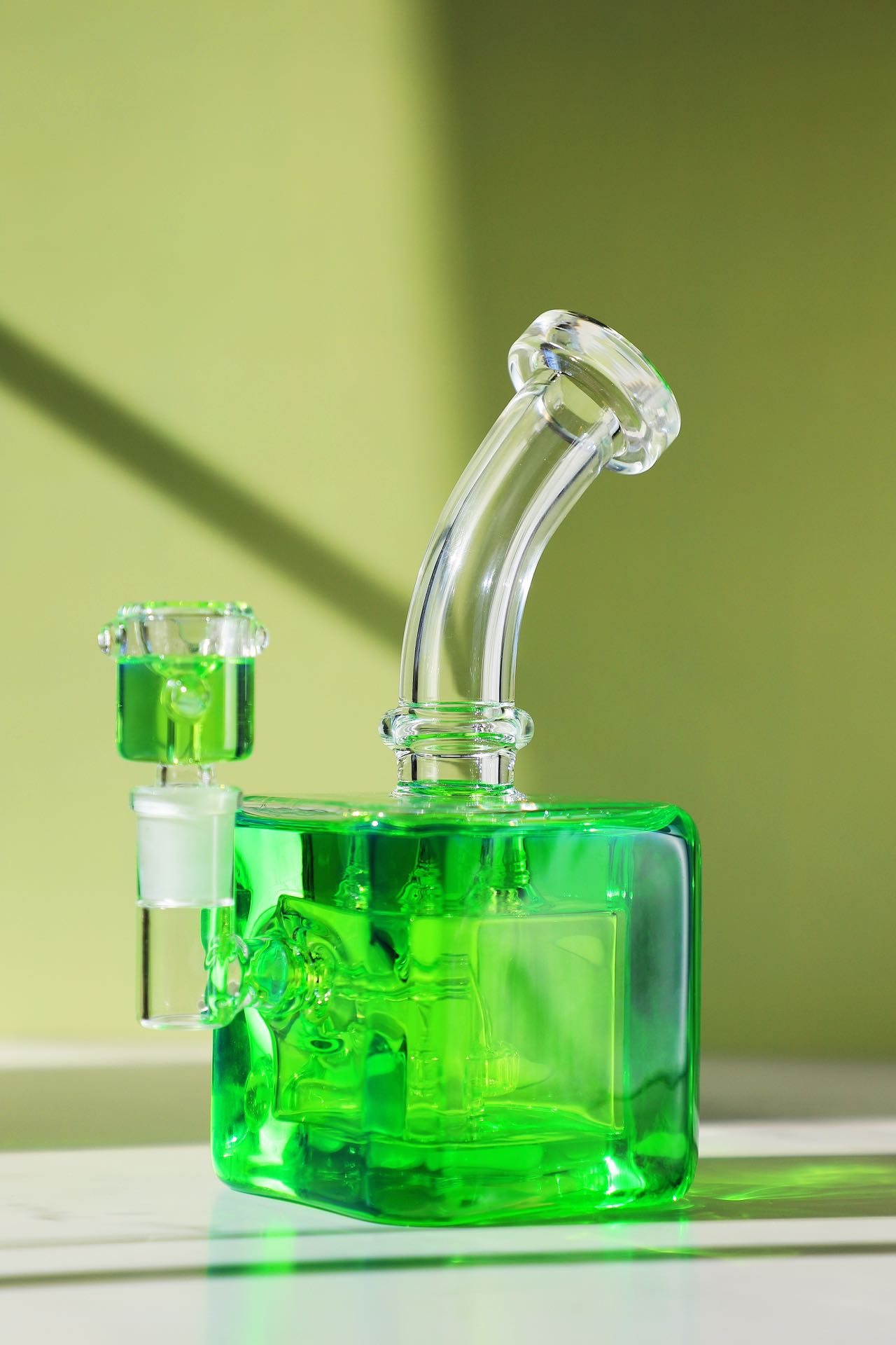 Unleash a frost-enhanced smoking experience with the Smooth Chill Glycerin Coil Bong collection. Featuring elegant glassware in vibrant red, purple, and green, these square-base, bent-neck bongs with ice catchers offer a modern smoke piece design for a sleek and sophisticated session