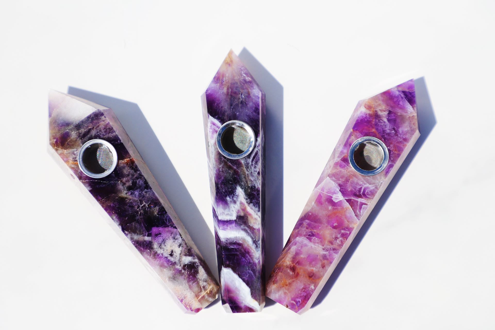 Exquisite Amethyst Crystal Smoking Pipe Set, showcasing a luxurious natural amethyst or black gemstone design with vibrant purple hues and crystalline patterns. This high-quality, portable smoking accessory is complete with a protective travel case, rainbow grinder metal mesh filters, and a cleaning brush for upkeep. Embrace the elegance of natural stone craftsmanship, perfect for enhancing the smoking experience with style and a touch of tranquility