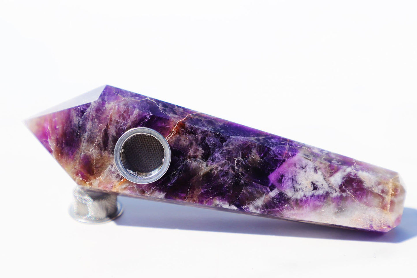 Exquisite Amethyst Crystal Smoking Pipe Set, showcasing a luxurious natural amethyst or black gemstone design with vibrant purple hues and crystalline patterns. This high-quality, portable smoking accessory is complete with a protective travel case, rainbow grinder metal mesh filters, and a cleaning brush for upkeep. Embrace the elegance of natural stone craftsmanship, perfect for enhancing the smoking experience with style and a touch of tranquility