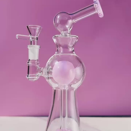 Enchanted Garden Mini Bong, the Ultimate Girly Glass Piece for Sophisticated Smokers with purple, pink, and green accents, offering an Ultimate Smooth Experience with Curve Percolator Bong, Green Glass Bong, and Advanced Filtration for a Sophisticated Smoking Session.